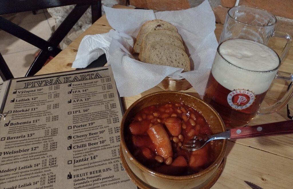 Dinner of sausages and beans with locally brewed beer at Prešov Pivovar, Prešov, Slovakia